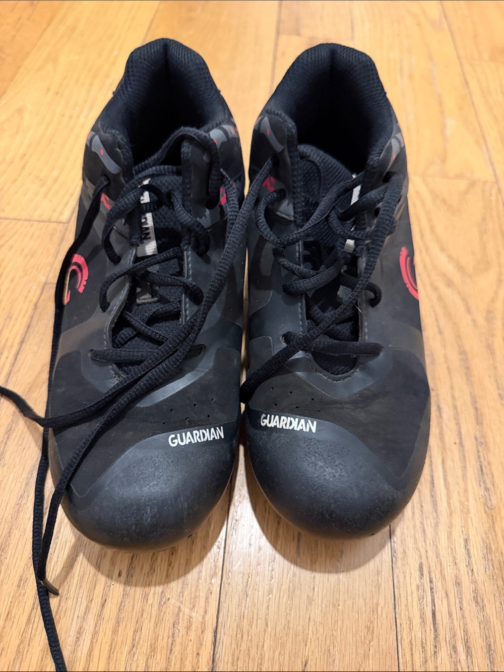 Guardian Black baseball cleats with red accents